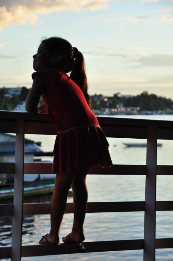 Menina se despede de Tefé, antes da partida para Manaus, no Amazonas